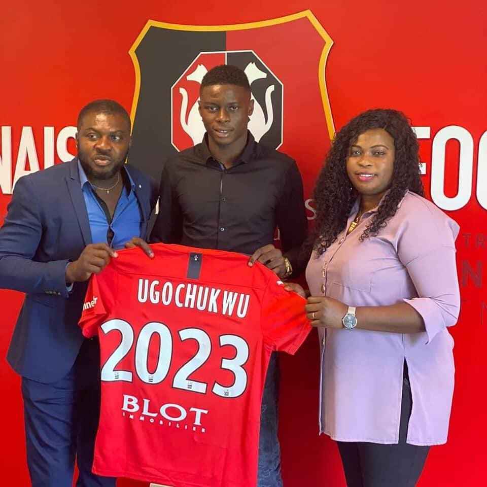 Lesley Ugochukwu, with his parents in a photoshoot, to commemorate his loan transfer.