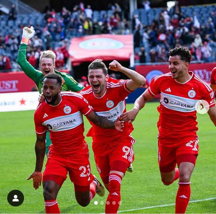 Image - Kellyn Acosta on the pitch celebrating a win with his teammates. Image - Kellyn Acosta on the pitch celebrating a win with his teammates.