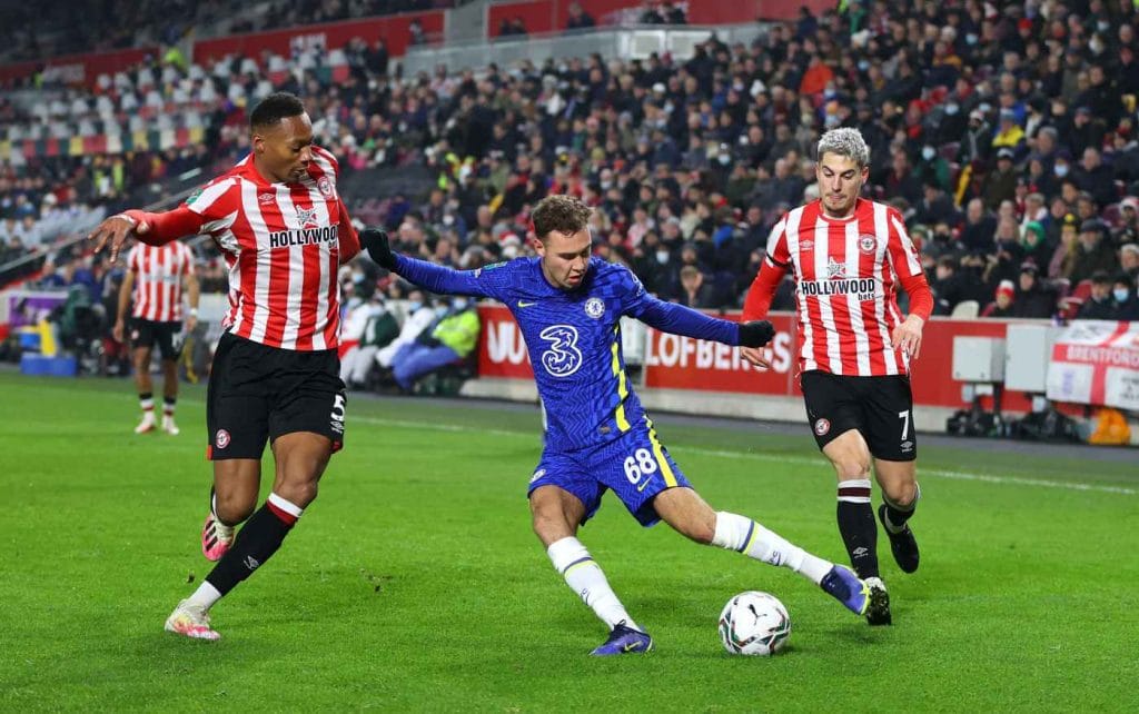 Image - Harvey Vale defending his club against two opponents.