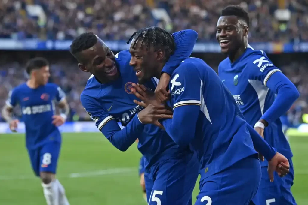 Image Axel Disasi with his teammates celebrating a win for their club.