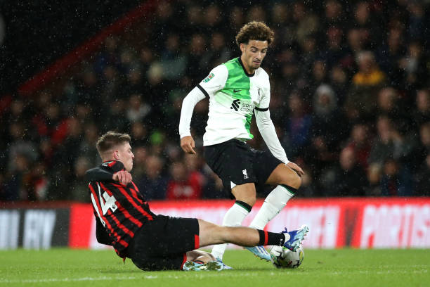 Alex Scott tackling Curtis Jones during a game.